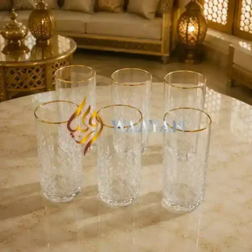 Set of six elegant glass tumblers with gold rim and delicate floral etching, perfect for any occasion.