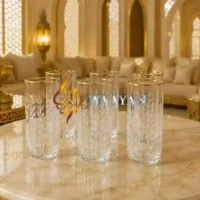 Elegant glass tumblers with intricate leaf patterns, featuring gold trim for a sophisticated touch. Perfect for any occasion.