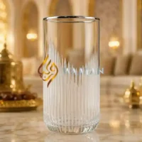 Elegant glass tumbler with a textured design, featuring a clear finish and subtle silver detailing. Perfect for any occasion.