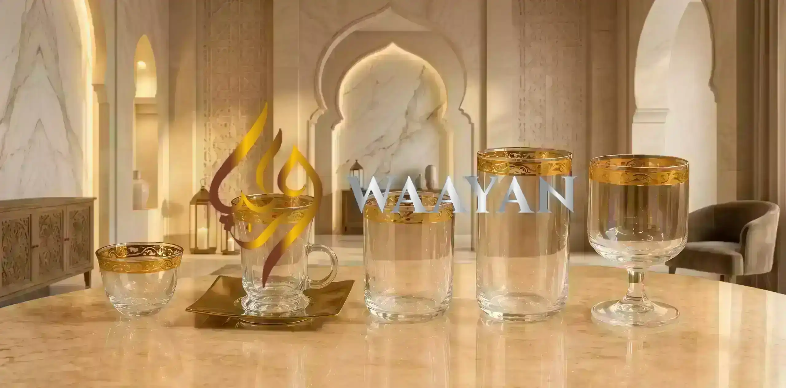 Clear glass drinkware set with ornate gold rim—teacup with handle and saucer, tumbler, highball, goblet, and small bowl.