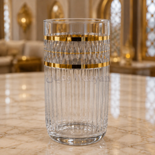 Clear glass tumbler with vertical fluting and a faceted band, accented by two gold bands around the middle