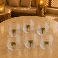 5-piece set of clear glass tumblers with palm tree print, top-down view