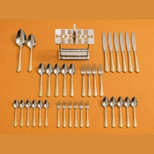 28 piece cutlery set with two-tone handles Cutlery pieces and stand arranged together against an orange background
