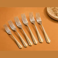 28 piece cutlery set with two-tone handles Forks with silver-coloured heads and gold-tone handles arranged diagonally