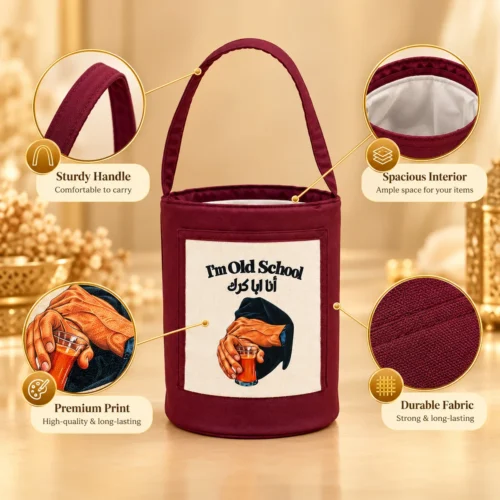 4F4E9814-3D8A-49D2-BD2B-9959BBD18760 Burgundy fabric cylindrical tote bag with canvas front print, single top handle, and white lined interior