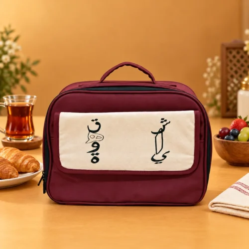 7AECB025-F4F9-4C75-B186-E86404C7C8EB Maroon fabric insulated food carrier bag with cream canvas front flap, top handle, and zippered closure