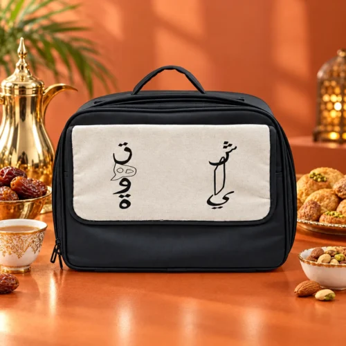 98A633C7-5498-45E4-855D-E327D29A3F51 Black fabric thermal food warmer bag with beige canvas front panel, top handle, and dual zipper closures