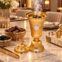 embossed gold metal incense burner with white inlays and a domed lid