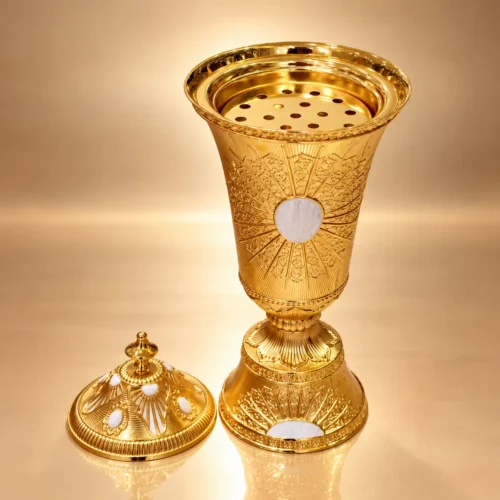 incense burner in polished gold embossed metal with white inlays, domed lid and perforated insert