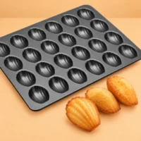 Mini Madeleine Pan, 24 Cavities, Non-Stick Close view of the ridged shell-shaped cavities in the madeleine pan